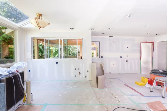 Chantier de rénovation intérieure d'une cuisine moderne avec cloisons sèches en cours d'installation